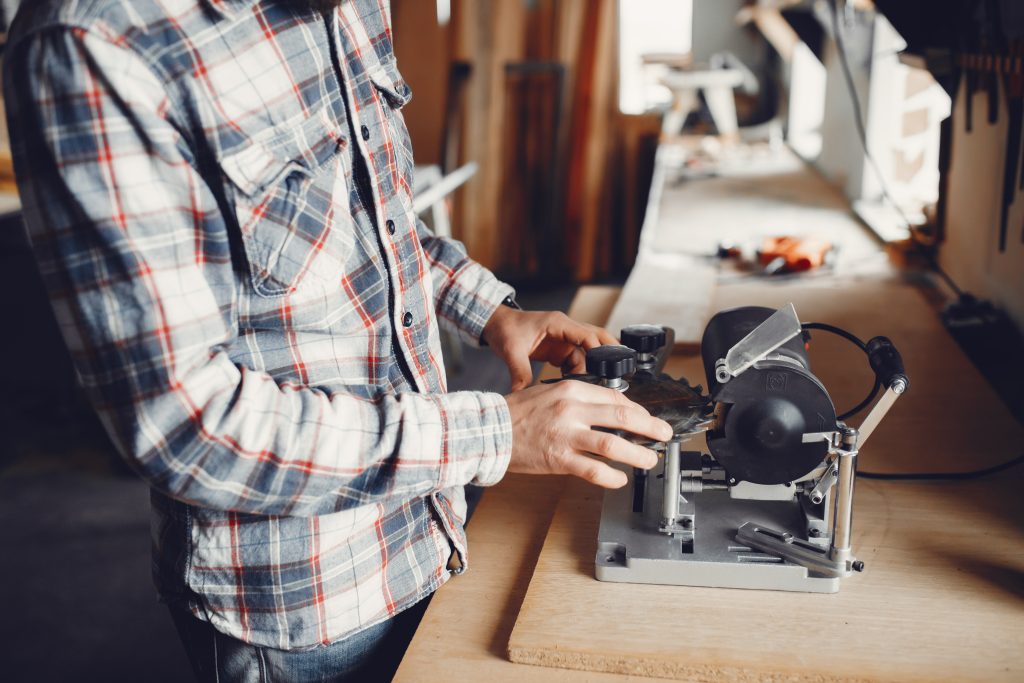 The carpenter works with a tree