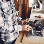 The carpenter works with a tree